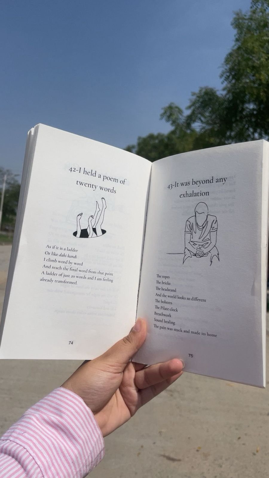 An open book of poems in daylight